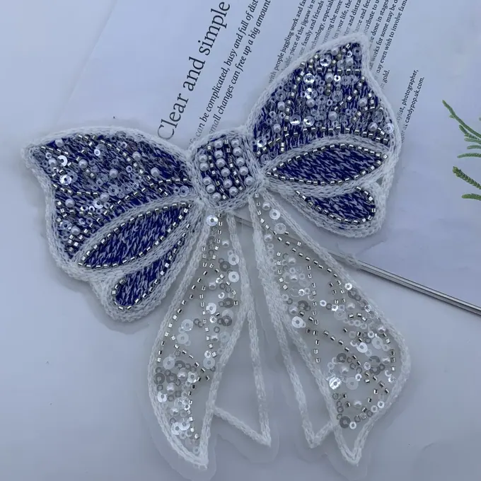 Beaded bow with ribbon tails · MET-4015 — product view