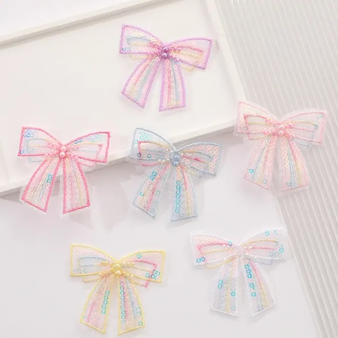 Single-layer embroidered bow appliqué · MET-8030 — product view