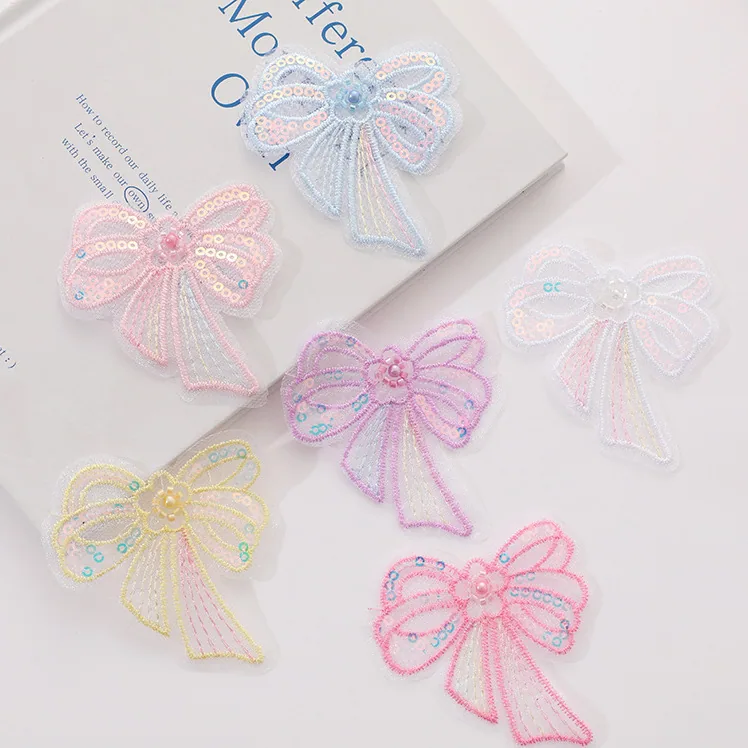 Single-layer embroidered bow appliqué · MET-8071 — product view