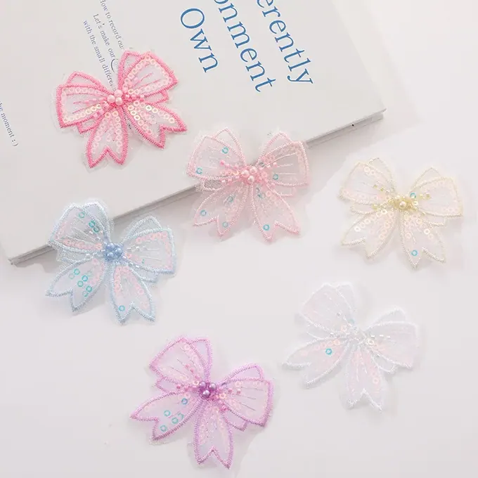 Single-layer embroidered bow appliqué · MET-8076 — product view